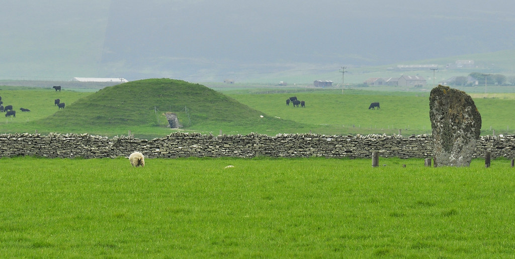 Green mound of Maeshowe; Barnhouse Stone in foreground The Neolithic chambered tomb in Stenness, with the Barnhouse Stone in the foreground, Orkney Islands, Scotland. www.Orkneyology.com