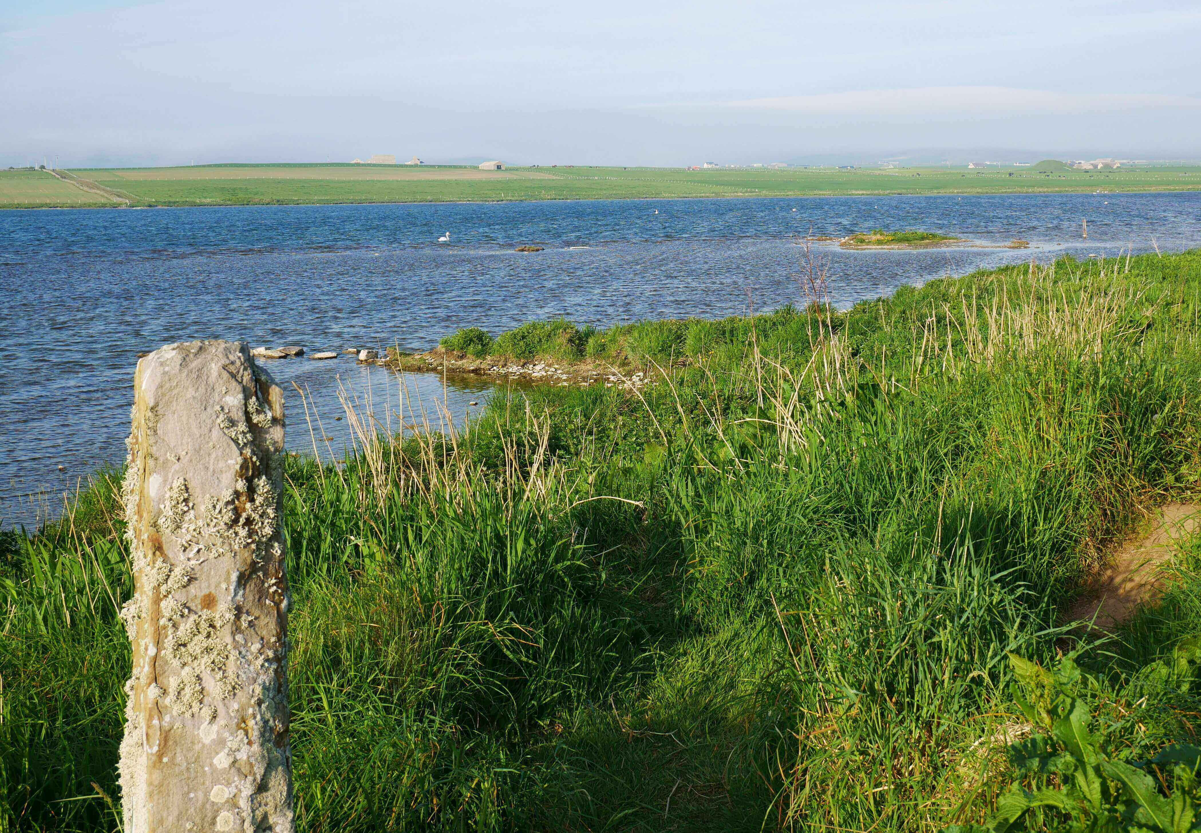 Maeshowe across the loch Distant view of Maeshowe from Barnhouse Neolithic Settlement, Orkney Islands, Scotland, UK.  www.orkneyology.com