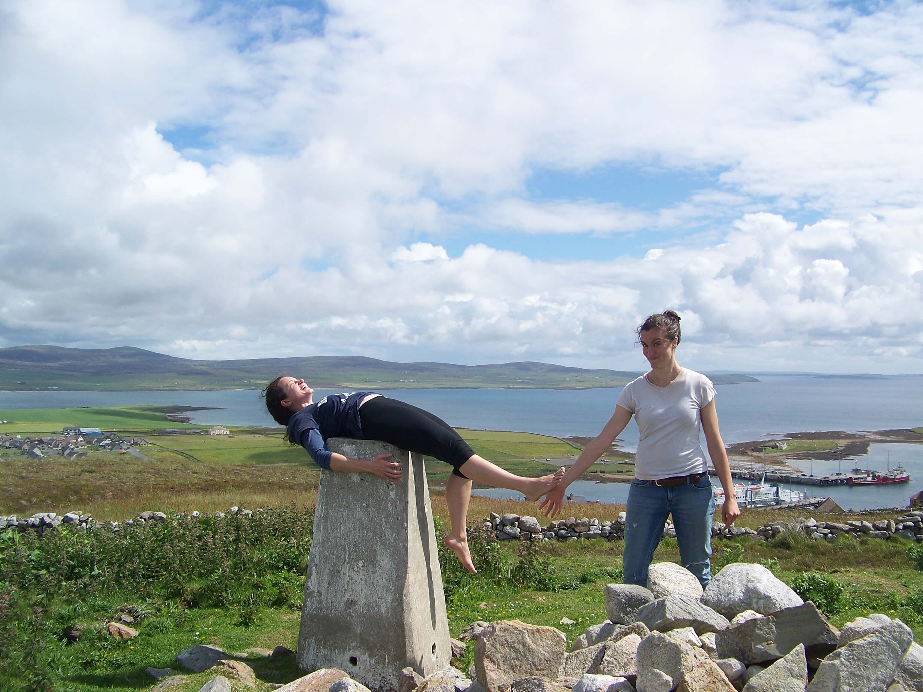 Bridgett torturing her sister with great affection Horseplay at trig point on the brae above Stromness