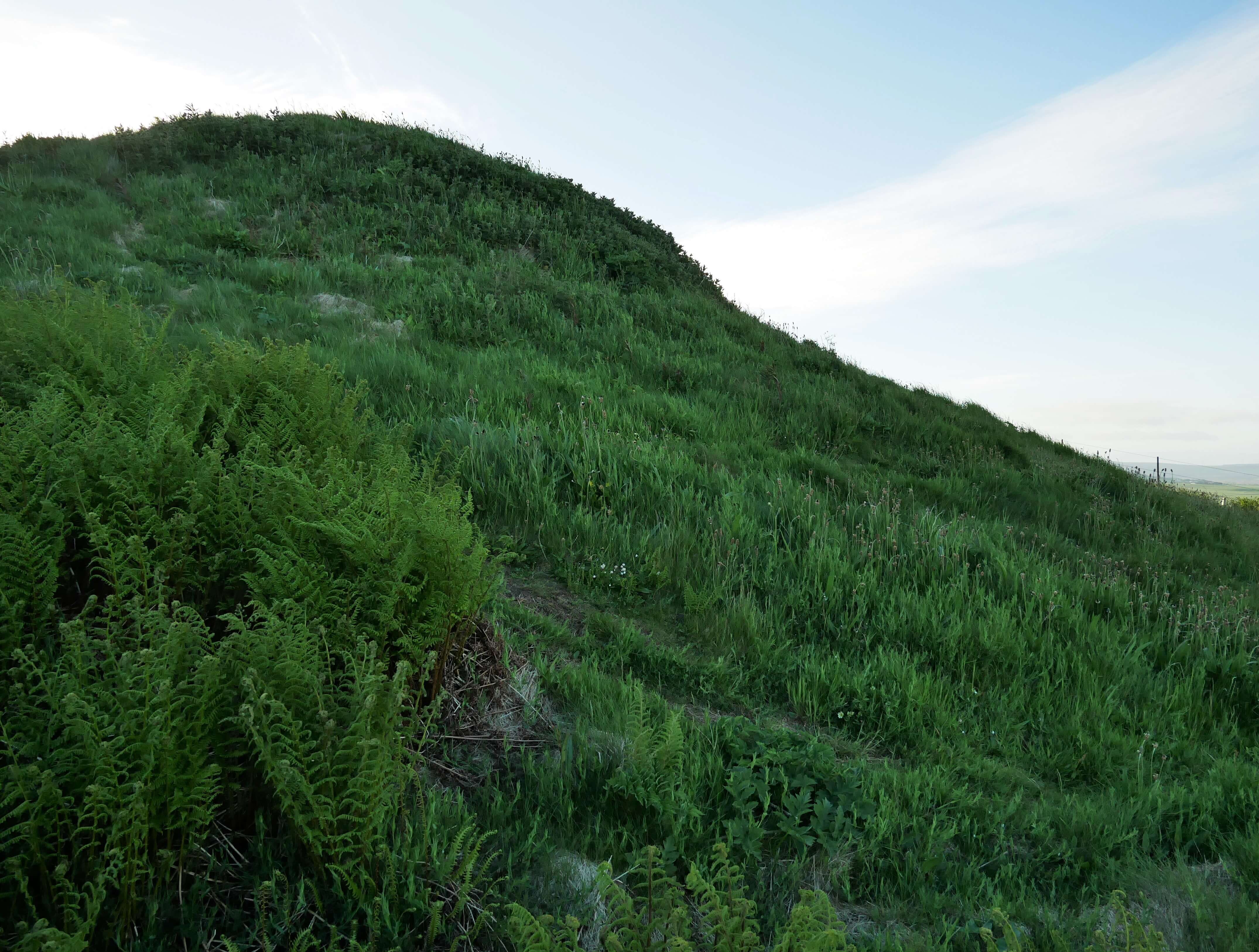 A fairy mound, Cuween Hill Tomb Cuween Hill Tomb in the Orkney Islands, Scotland