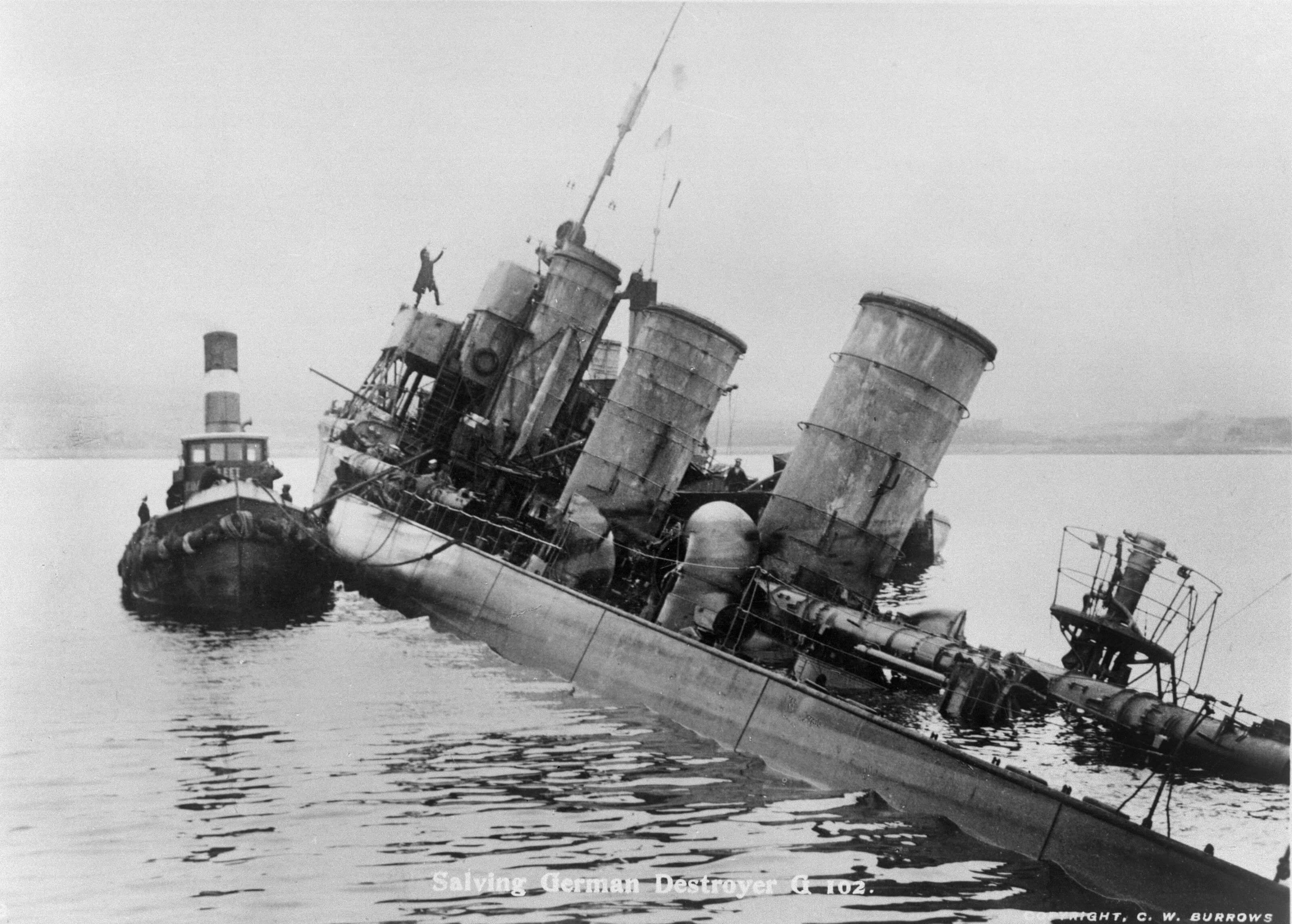 British sailor hauling down the German flag and putting up Union Jack, WWI German High Seas Fleet scuttling in Orkney Islands' Scapa Flow - Orkneyology.com