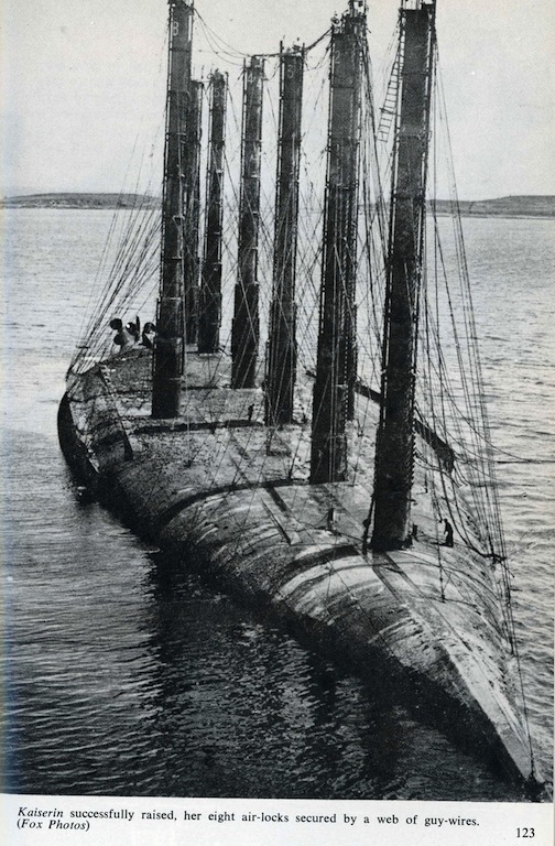 Salvage work on upside-down German ships after WWI scuttling of German High Seas Fleet in Orkney's Scapa Flow, Scotland