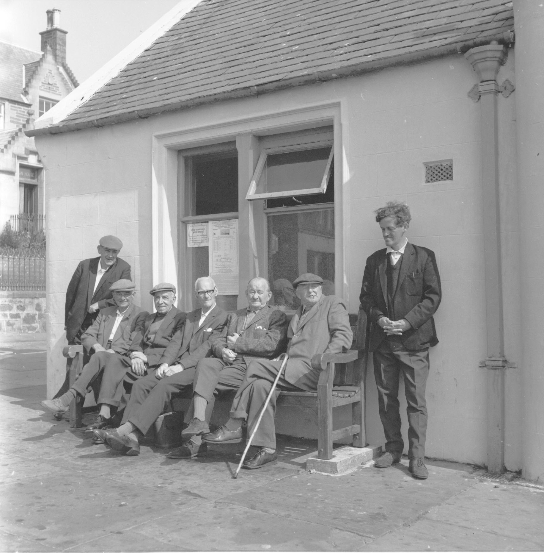 Stromness writer GMB and a group of old men affectionately known as "the Pierhead Parliament." Stromness, Orkney Islands, Scotland - www.orkneyology.com