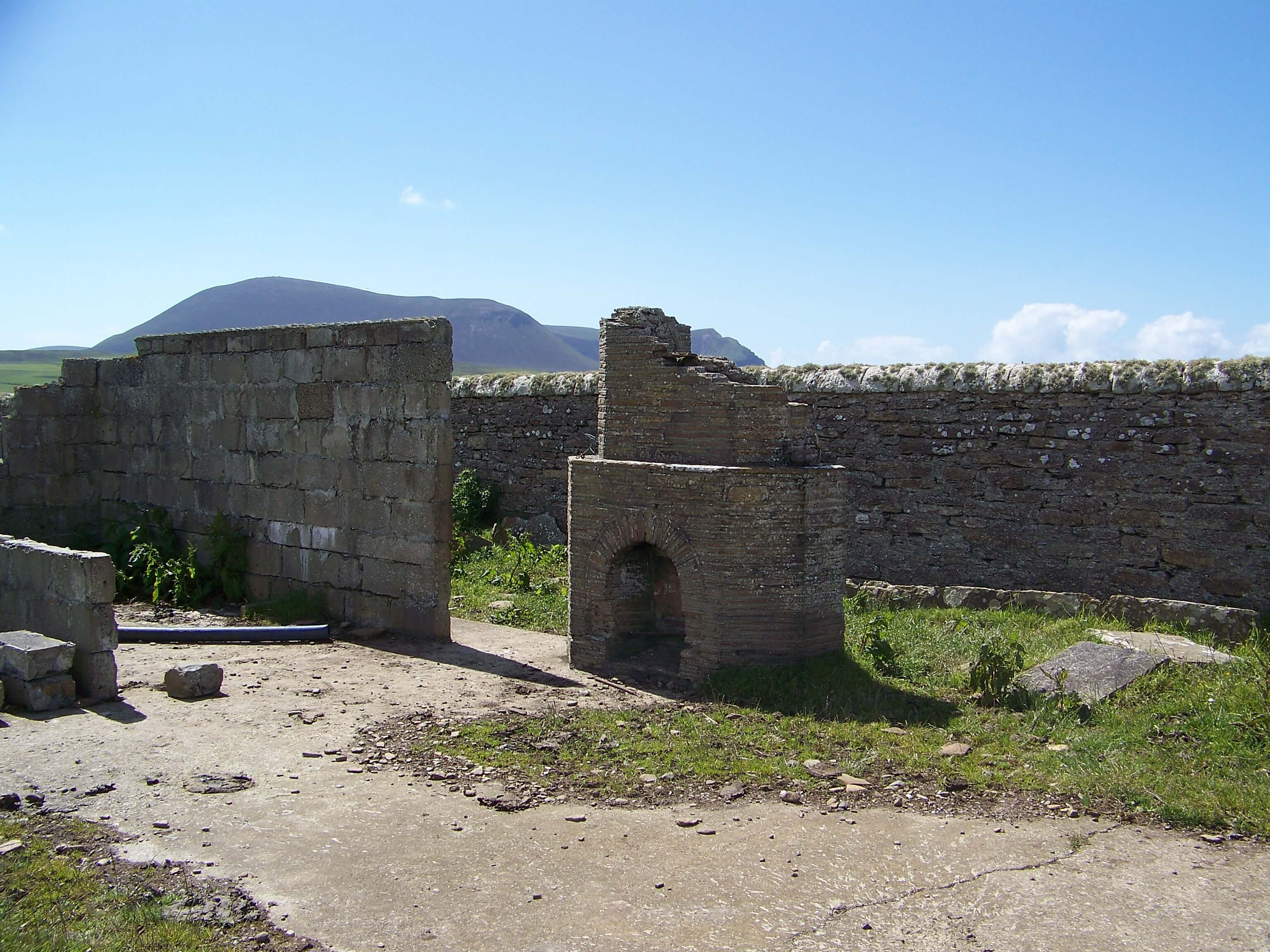 Remains of a WWII military structure near Hoy Low - Tom guesses it might have been an officer's mess, due to the more ornate brick fireplace than was usual for enlisted men. Remains of WWII battery, Orkney