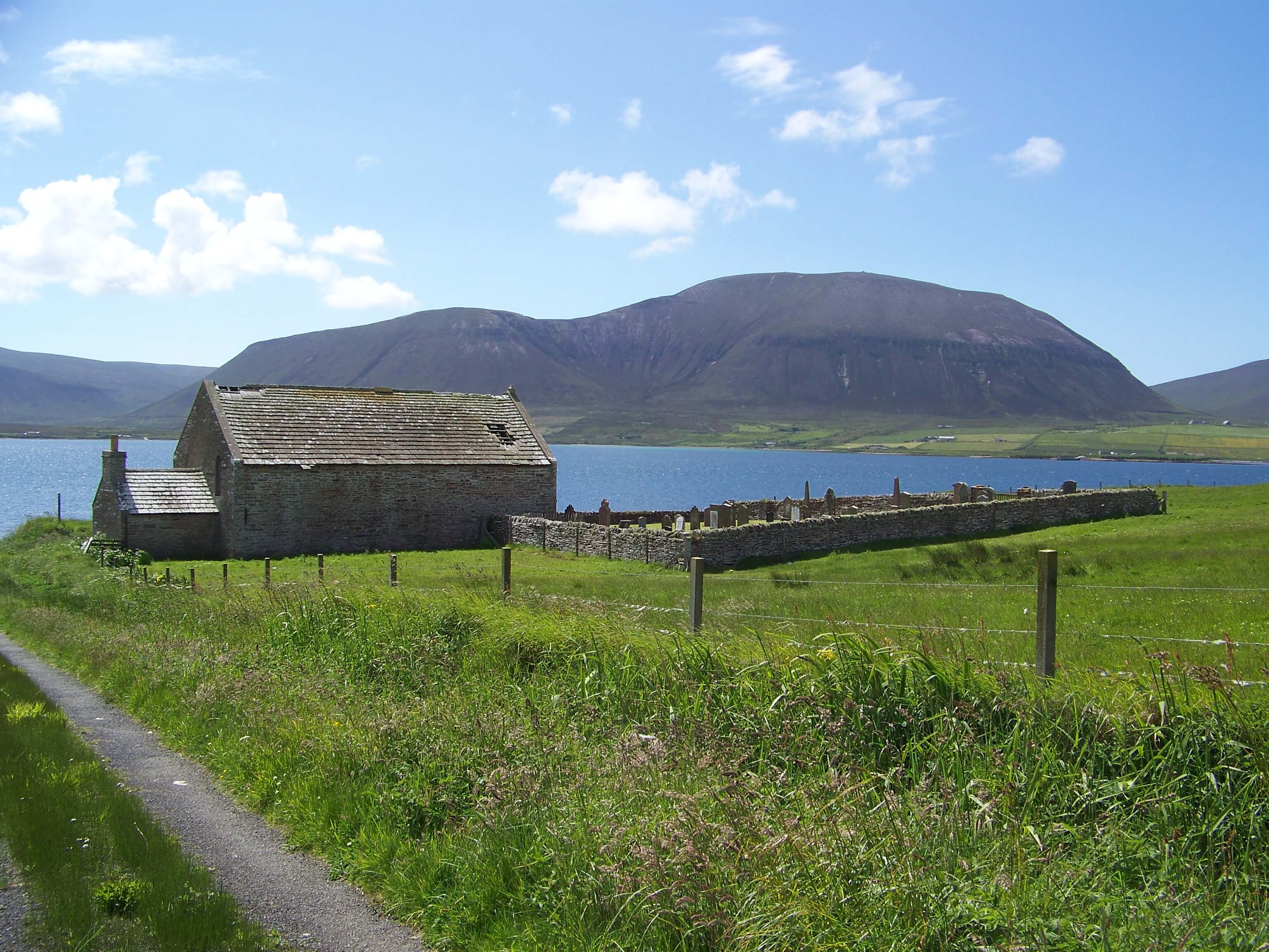 The old kirk and cemetery, with the Hoy hills in the background Old kirk, Orkney island