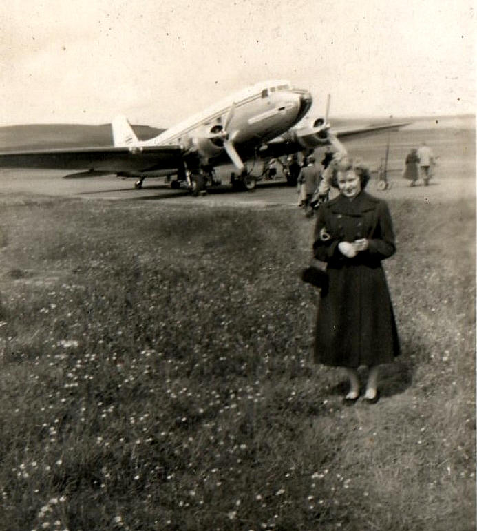 A woman at Grimsetter/ Kirkwall Airport in the early 1950s, in front of a BEA Dakota. Tankerness, Orkney Islands, Scotland.  www.orkneyology.com