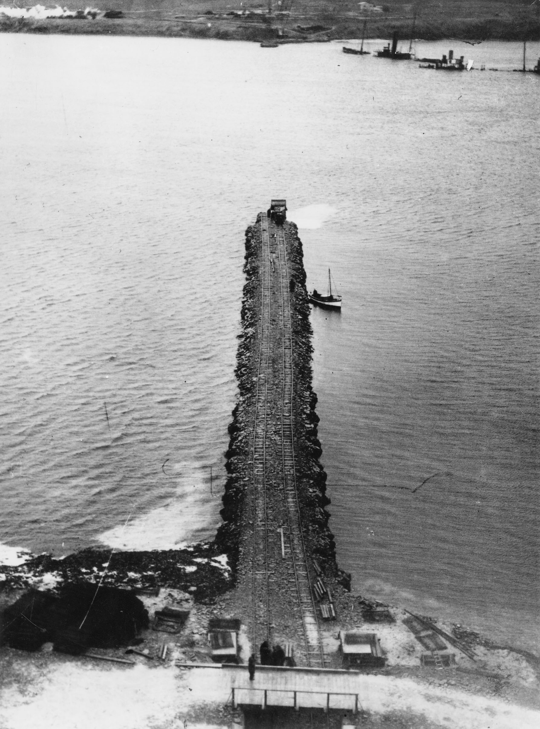 From South Ronaldsay to Burray, the 4th-Barrier, Water Sound. Blockships in the background. WWII Orkney Islands, Scotland - building the Churchill Barriers. From South Ronaldsay to Burray, the 4th-Barrier, Water Sound. #Orkneyology.com