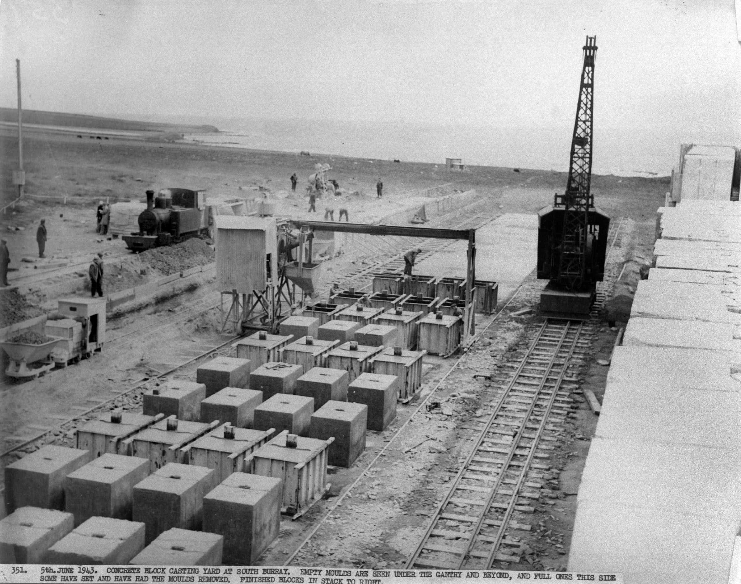 The block works in Burray where the men made concrete blocks for the barriers. The small crane is to move blocks. Blocks moulds (both empty and full) are on the left and finished blocks to the right. The Churchill Barriers being built by WWII Italian POWS and others in Scotland's Orkney Islands. www.Orkneyology.com