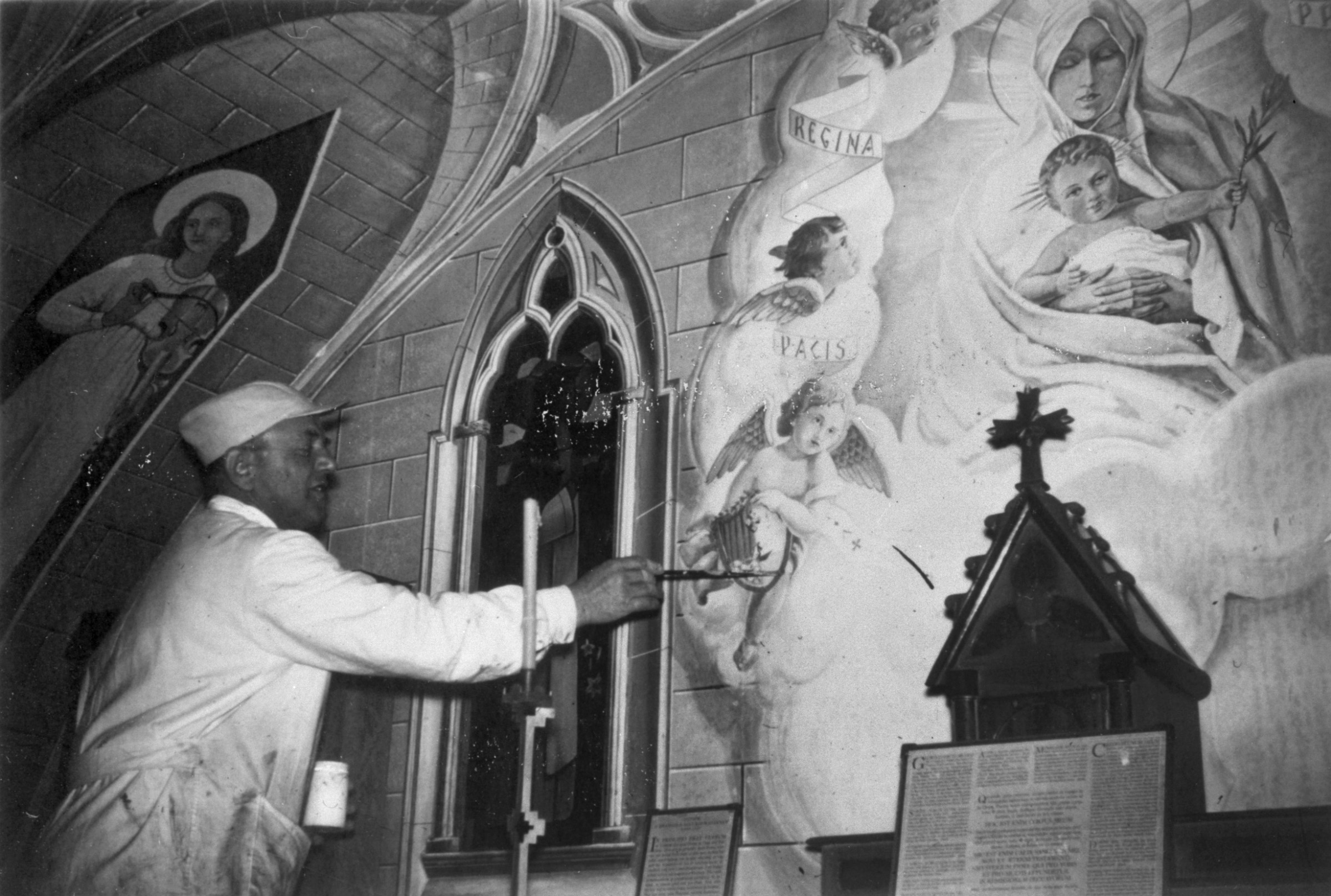 Domenico touches up the heraldic shield of Moena Domenico Chiocchetti, former Italian POW in the Orkney Islands, Scotland, re-visits his chapel in Lamb's Holm, Orkney to make repairs to his paintings. www.Orkneyology.com