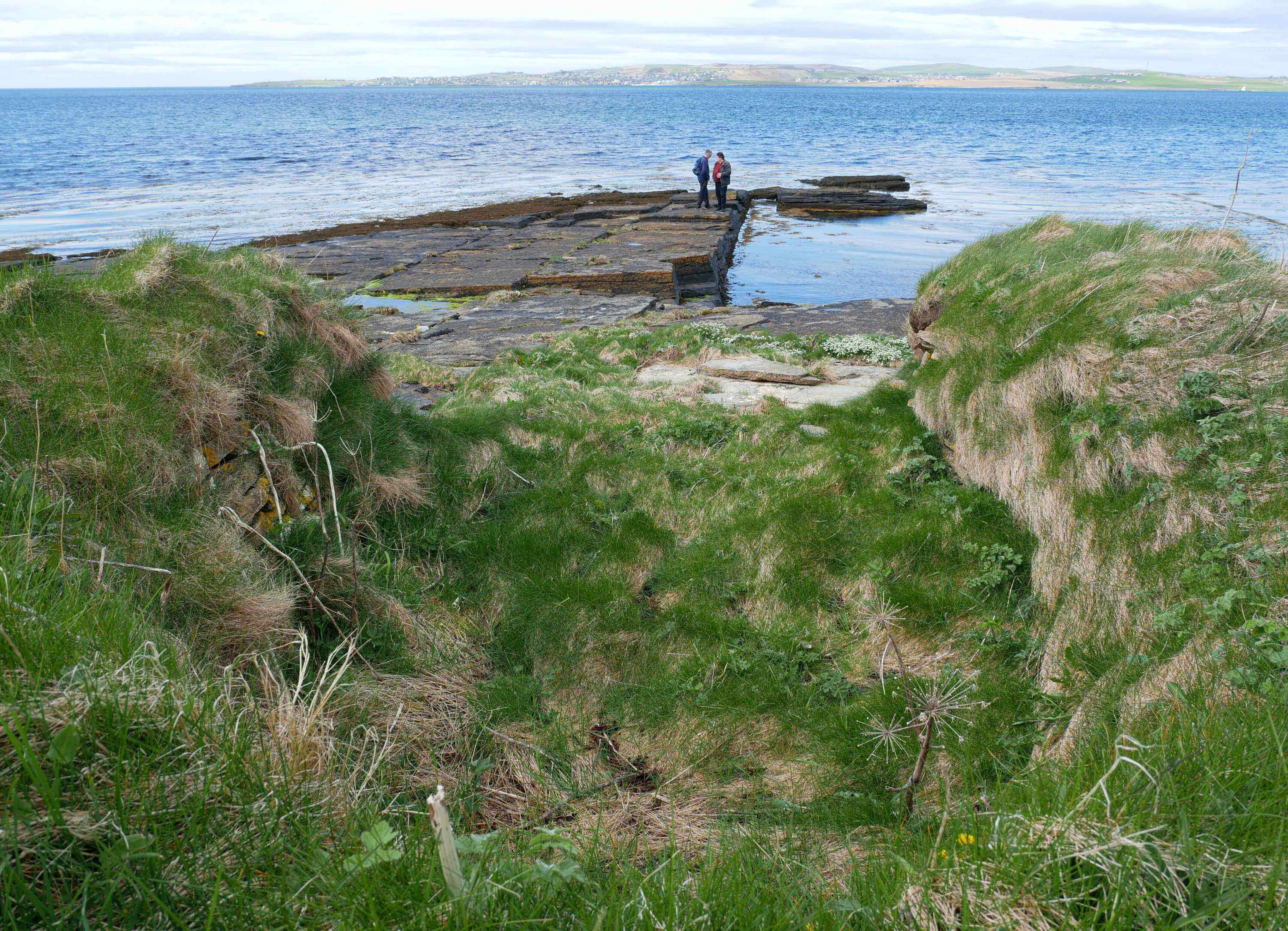 Tom Muir and Ken McGoogan, exploring Rae's old stomping grounds. The boat noust is the indentation in the foreground. Tom Muir and Ken McGoogan explore the boat noust at the Hall of Clestrain, Orkney - Arctic explorer Rae's old stomping grounds