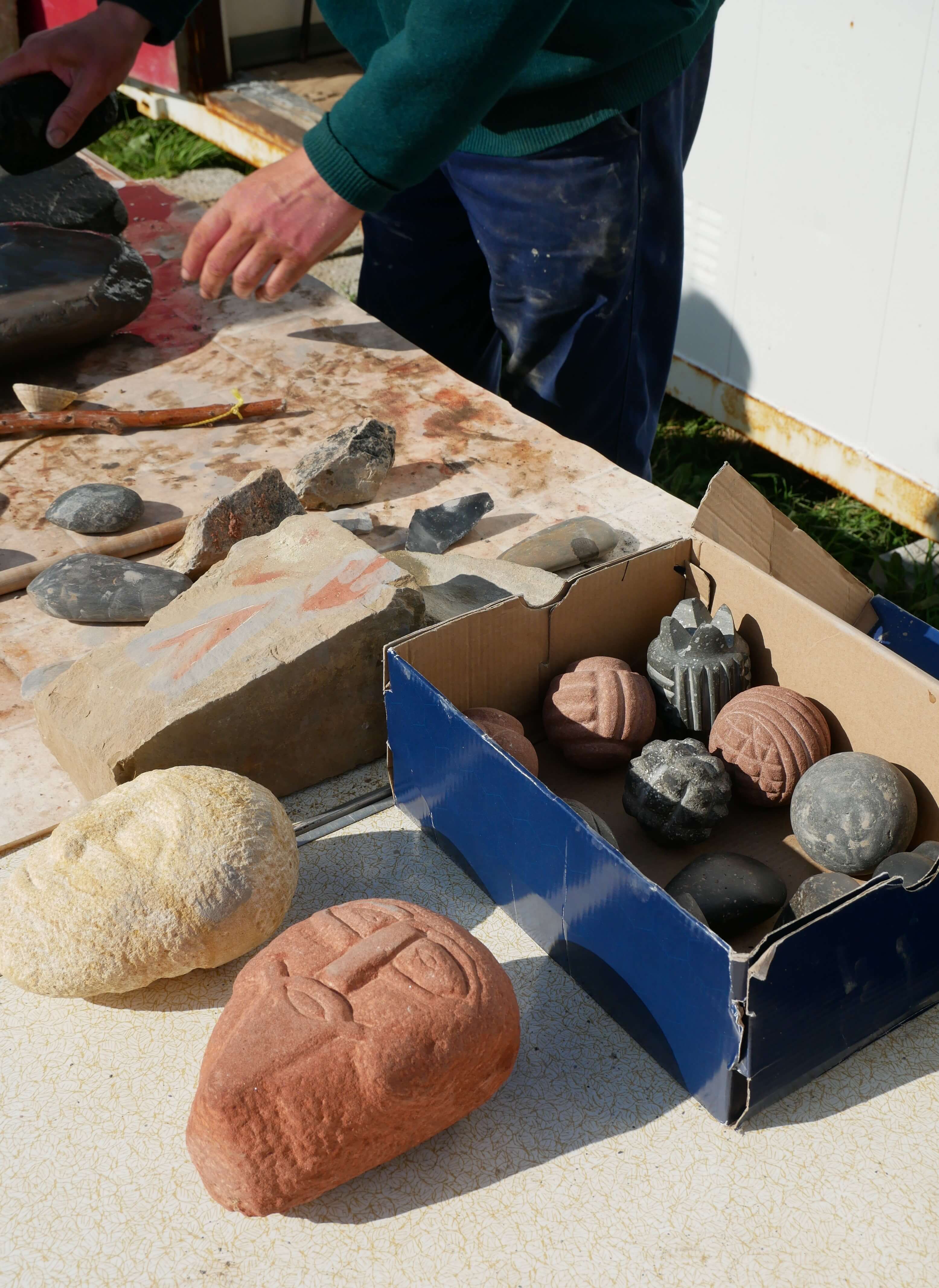 Chris Gee, Orcadian archaeologist, demonstrates making Neolithic carved balls and faces, Ness of Brodgar dig open day, Stenness, Orkney, Scotland, UK
