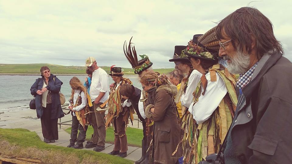 Orkney tour guide Jo Jones guiding the Domesday Morris Dancers at Skara Brae, 2017. Local Experts Orkney travel tips on Orkneyology.com