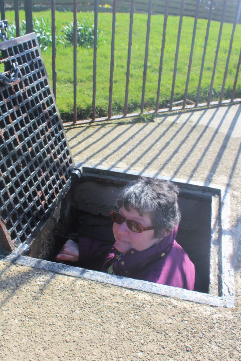 John's wife, Gillian at Rennibister Earth House John Foster's Trike Tours. John's wife and partner, Gillian, coming out of Rennibister Earth House. Orkneyology.com