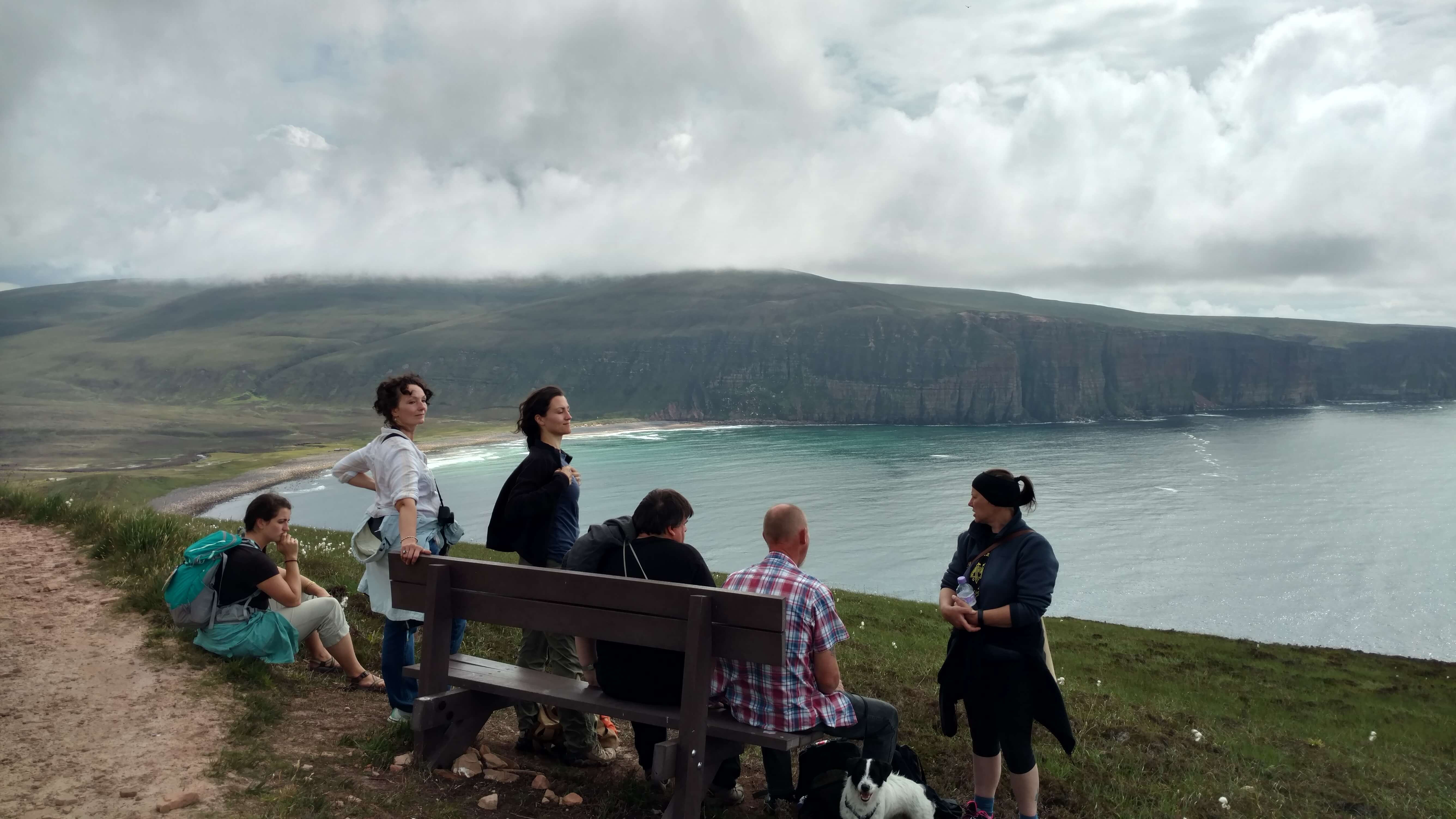 Hikers taking a break on a bench - the Old Man of Hoy walking trail.