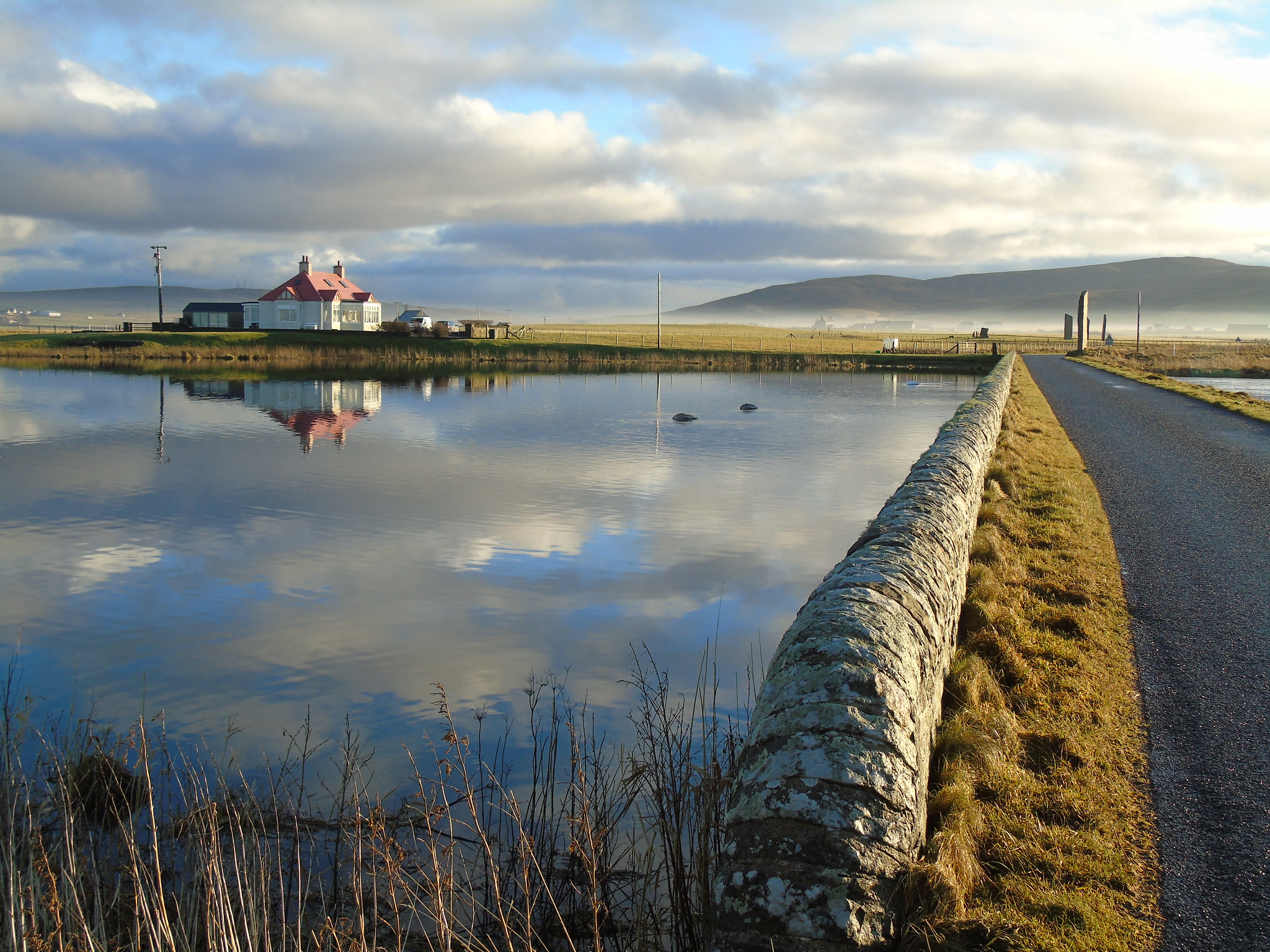 Looking back toward the stones Odin Cottage in Stenness, Orkney, Scotland, looking toward the Watch Stone and stone circle at Stenness. Orkneyology.com
