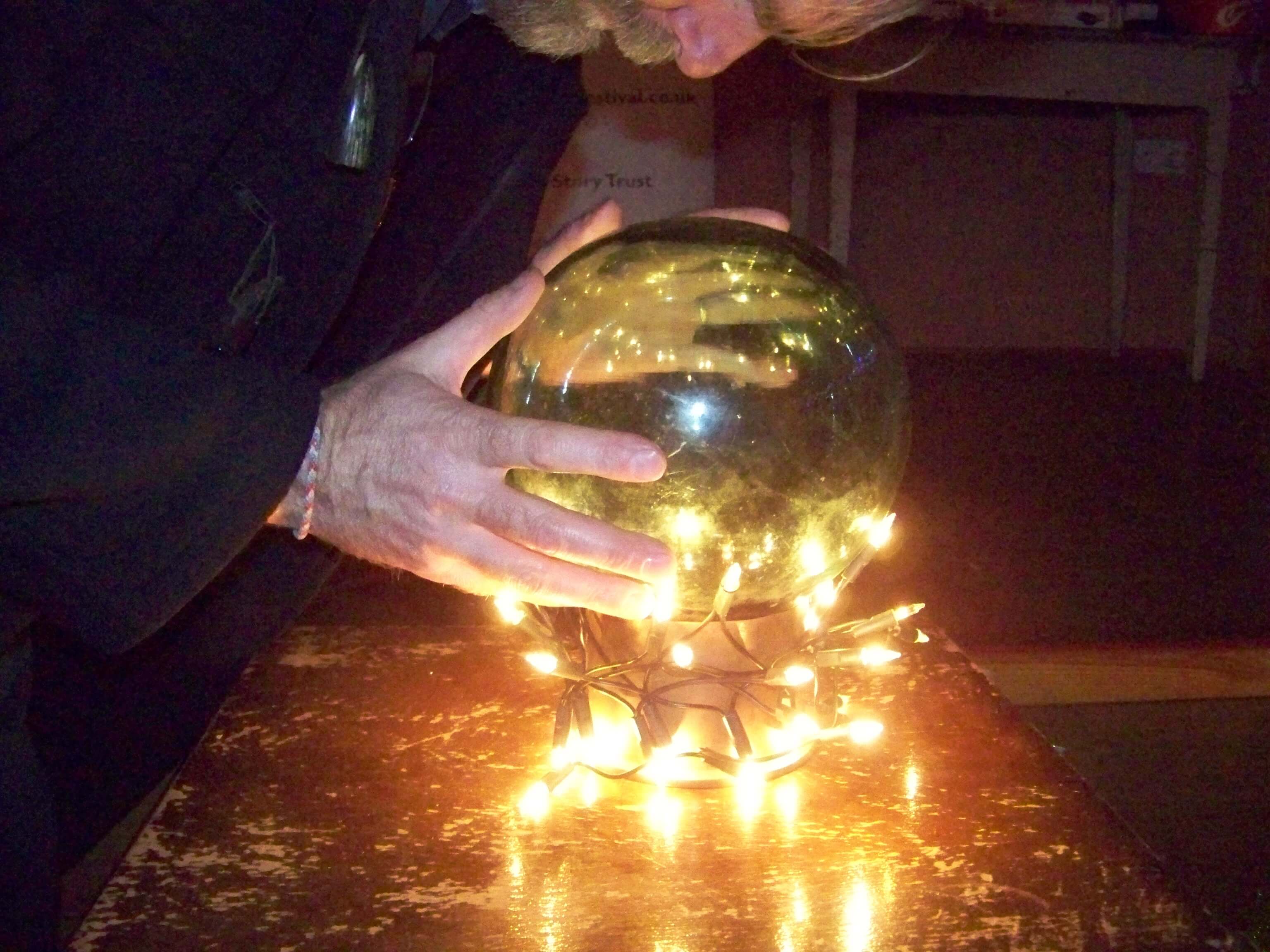 Andy Hollinrake looks into his magic ball of stories Andrew Hollinrake looks into his crystal ball at a storytelling event in Orkney, Scotland