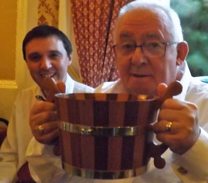 Our friend, traditional bothy singer Scott Gardiner, and Lawrence - drinking the bride's cog at our wedding celebration Bothy singer Scott Gardiner and traditional Shetland storyteller Lawrence Tulloch drinking the bride's cog at the celebration of storyteller Tom Muir's marriage in the Orkney Islands.